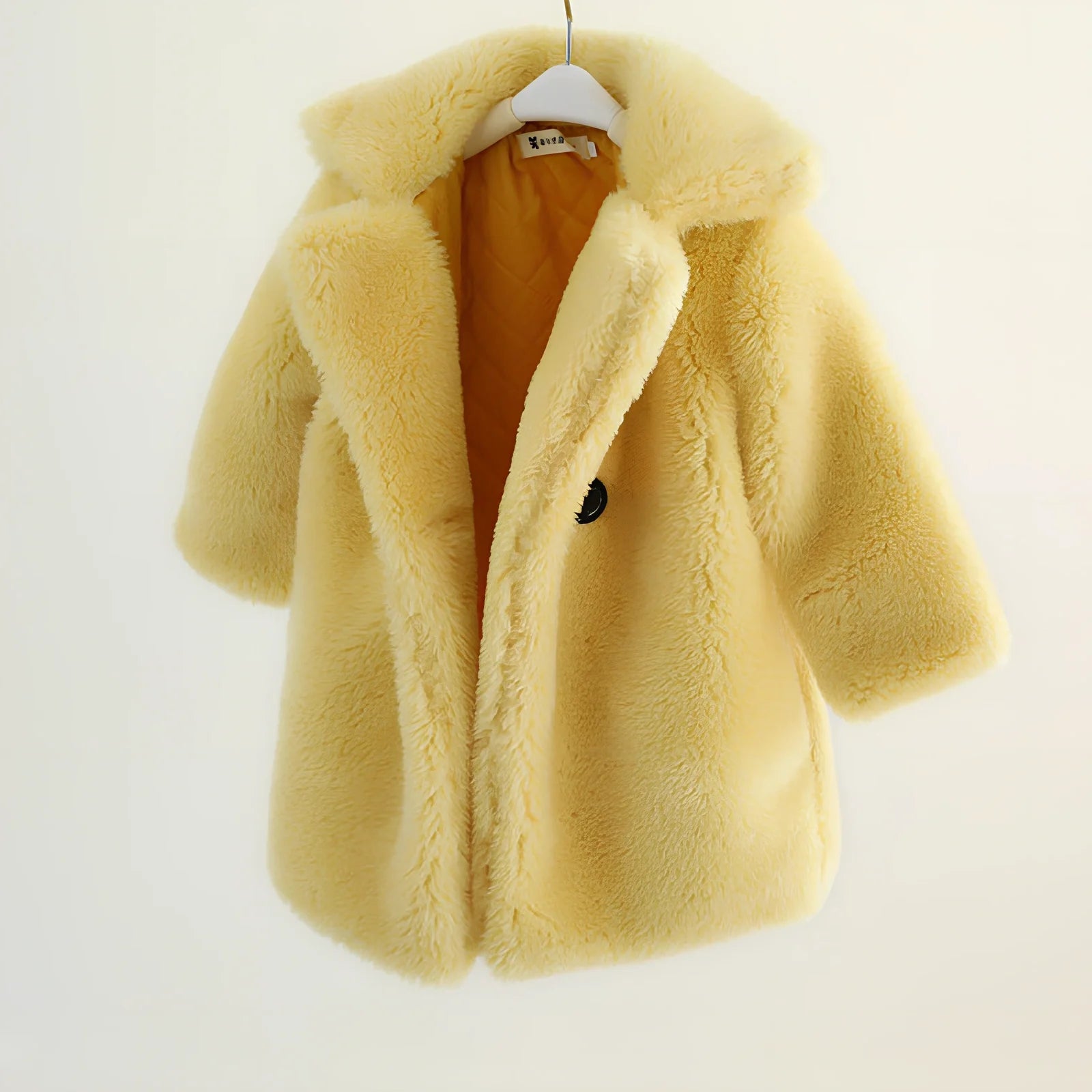 Children's cashmere fur coat in beige colour with suit collar and long sleeves for winter wear