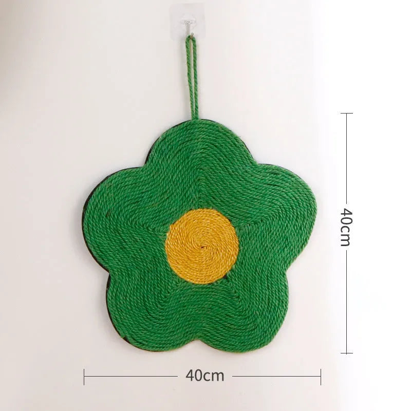 Green floral sisal cat scratching board on a wooden floor.