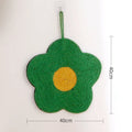 Green floral sisal cat scratching board on a wooden floor.