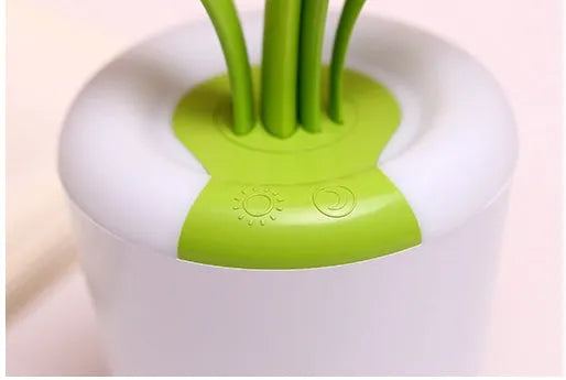 Modern rechargeable LED table lamp in pink with touch control and plant-shaped design on a wooden desk