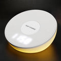 White wireless phone charger with LED digital clock display and three control buttons on the front.