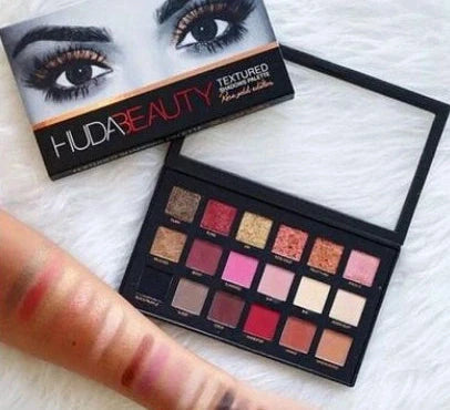 18 colour eye shadow palette open showing 12 matte and 6 shimmer shades with dual-ended brush