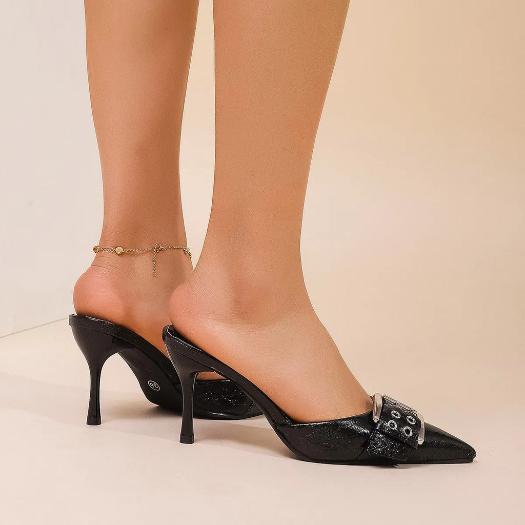 Black women's high heels with pointed toe and ankle strap featuring a decorative buckle.