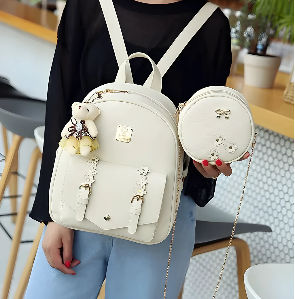 Women's three-piece floral PU leather bag set showing backpack, crossbody shoulder bag, and card holder
