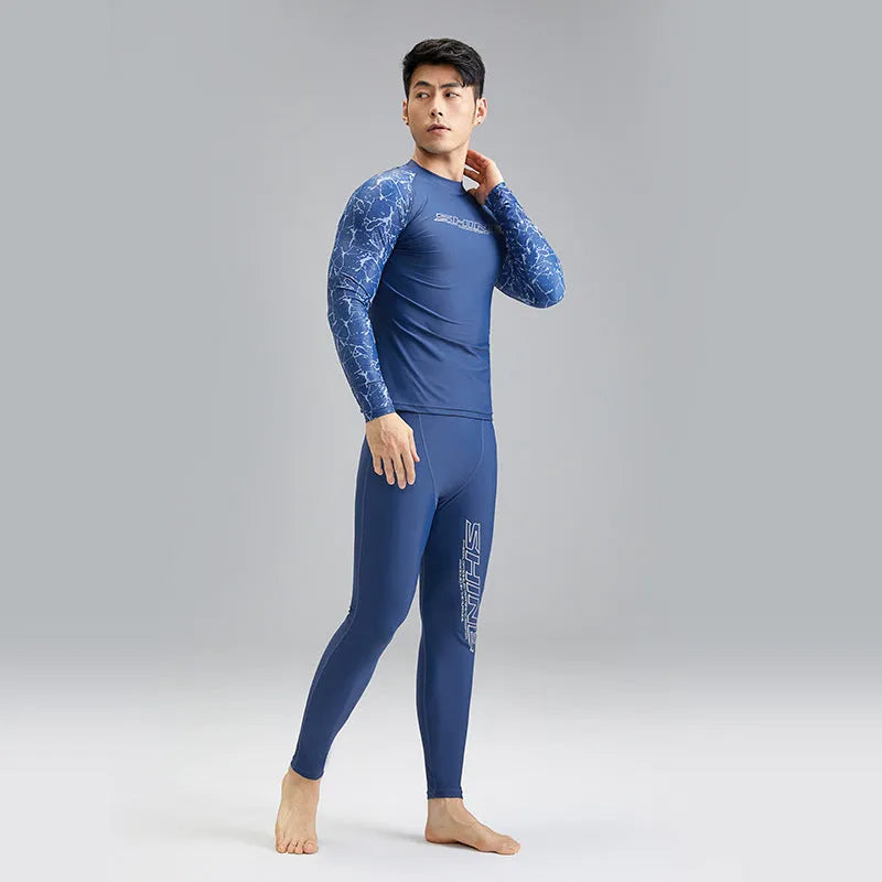 Men's dark blue patterned swim vest and matching swim trunks set on a white background.