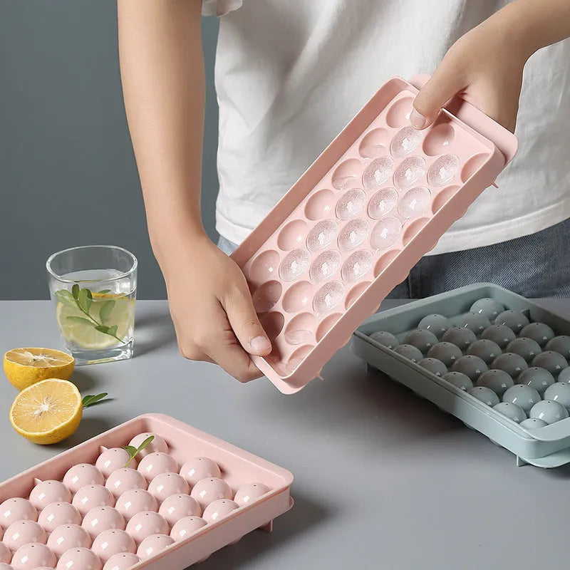 Sky blue and pink round ball ice cube trays showing 18 and 33 grid options