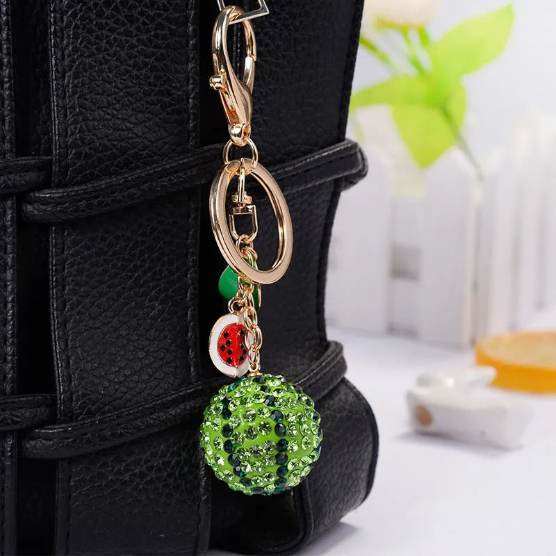 Green zinc alloy watermelon slice keychain measuring 12cm.