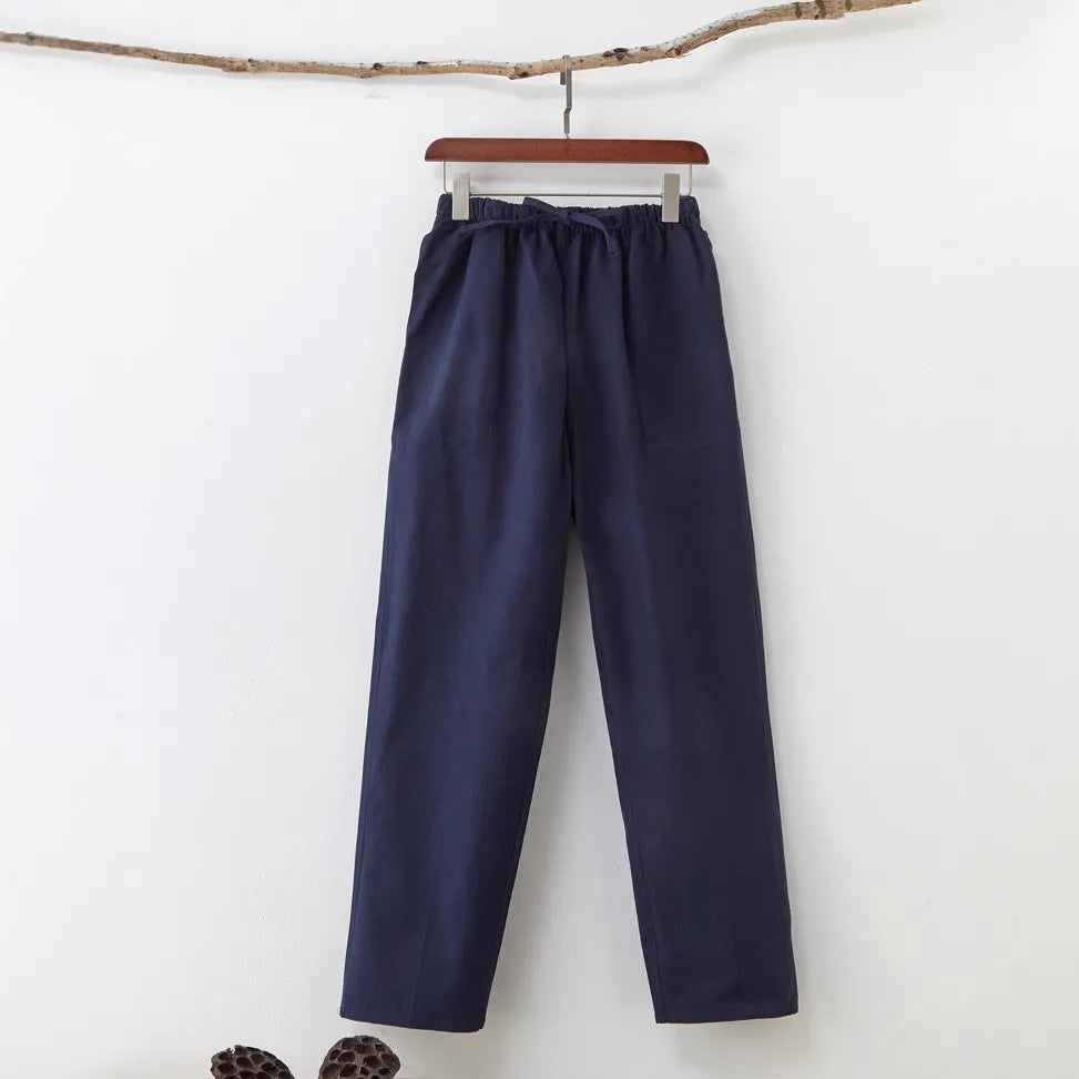 Men's solid colour cotton casual trousers with belt in beige, showing mid waist and drawstring design