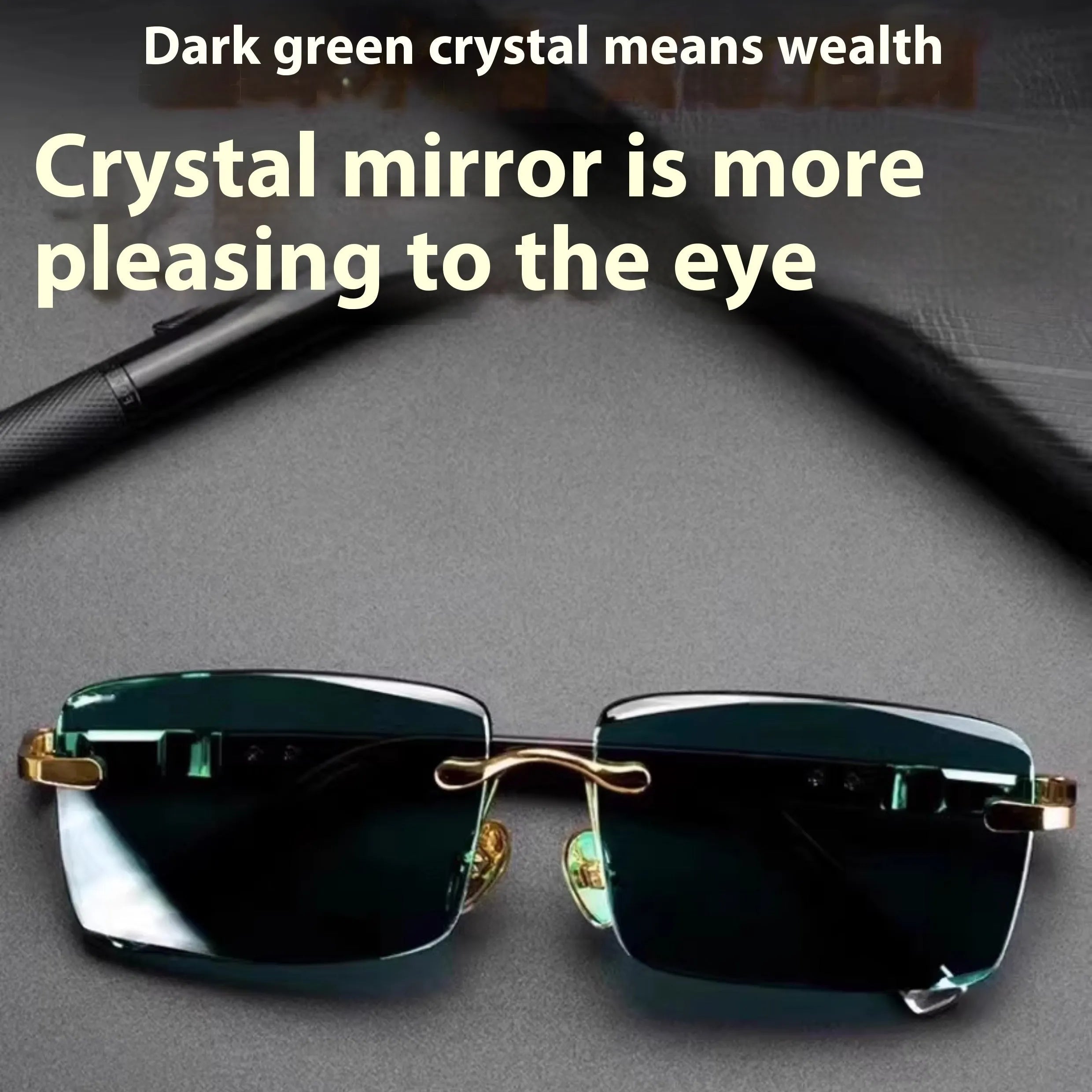 Dark green crystal frameless sunglasses with a case and cleaning cloth on a table.