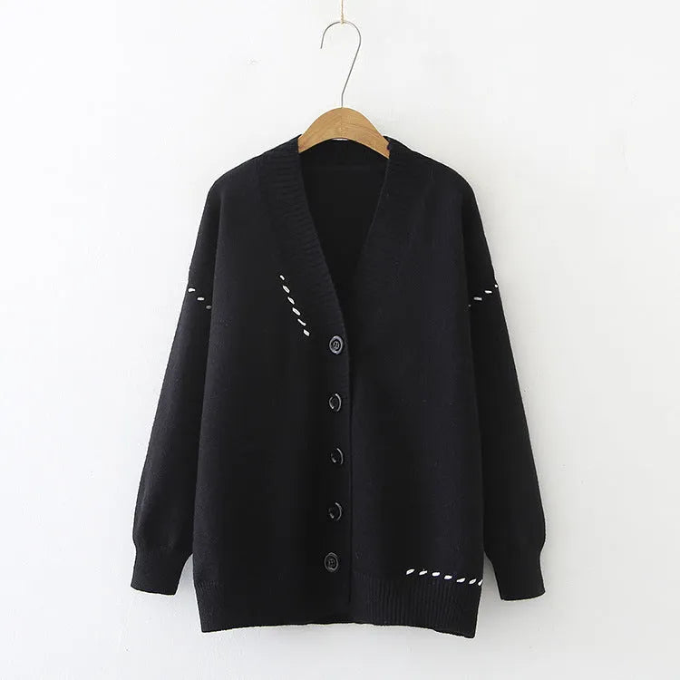 Women's loose fit long sleeve knitted cardigan coat in black or white.