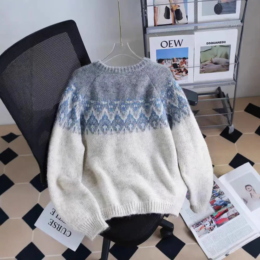 Women's loose beige jacquard knit coat sweater with long sleeves on a hanger