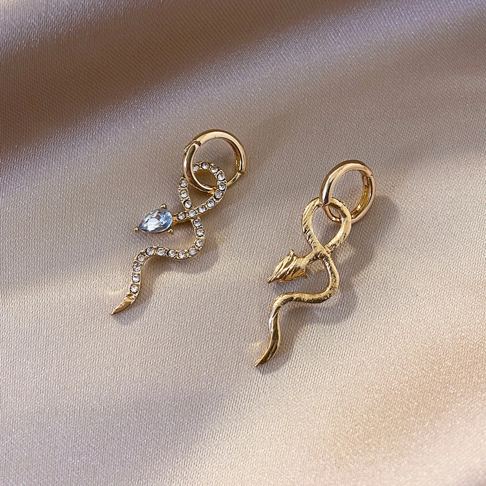 Elegant snake-shaped dangle earrings with a golden hue, showcasing a blend of European and American style