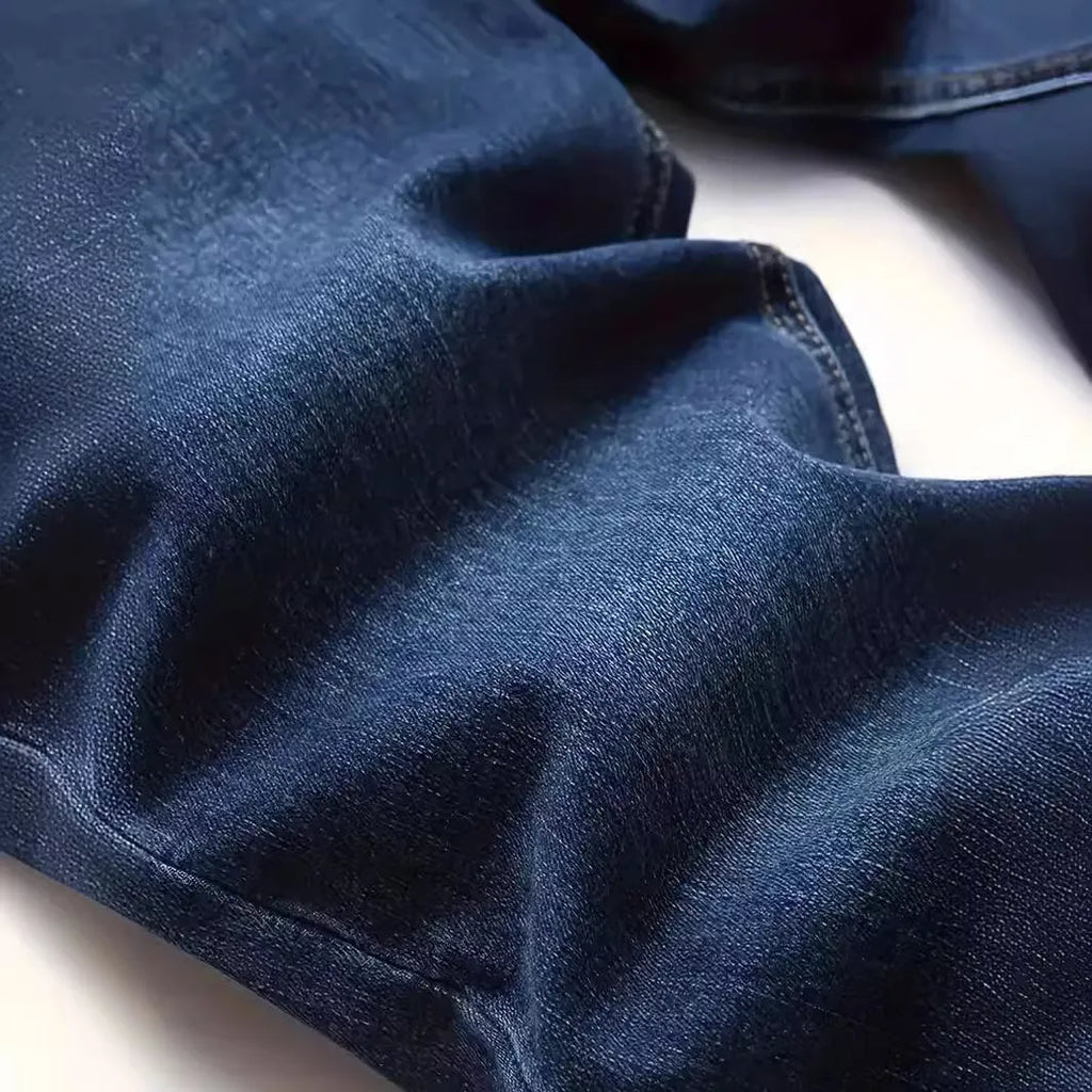 Men's dark blue slim-fit elastic cotton jeans with a skinny leg opening.