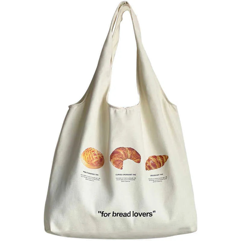 Beige canvas shoulder bag with bread design showing front width and shoulder strap