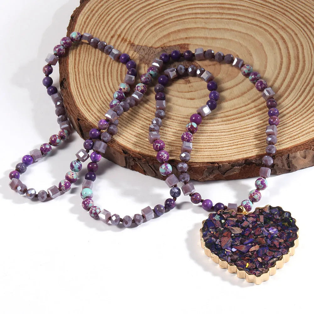 Bohemian style long chain heart pendant necklace in stone and glass with electroplated finish, available in multiple colours.
