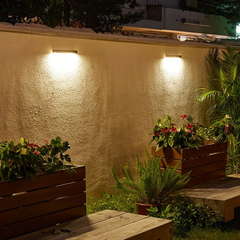 Black solar-powered outdoor wall lamp with IP65 waterproof rating for garden and patio lighting