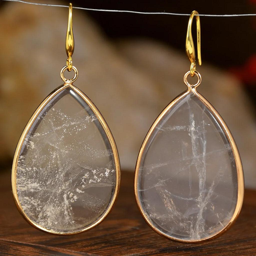 Close-up of women's retro water drop pendant earrings made from natural stone in a selection of colours.