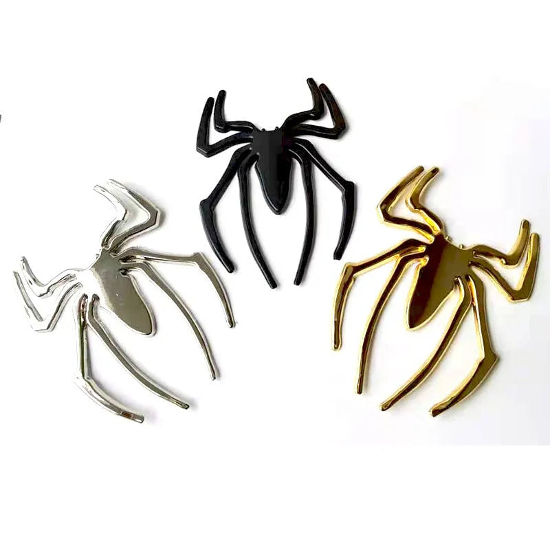Three-dimensional metal spider bumper sticker in metallic finish.