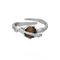 White gold colour Saturn open ring with adjustable opening on silver background