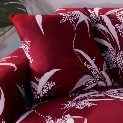 Printed stretchable sofa slipcover covering a three-seater sofa in a modern geometric pattern