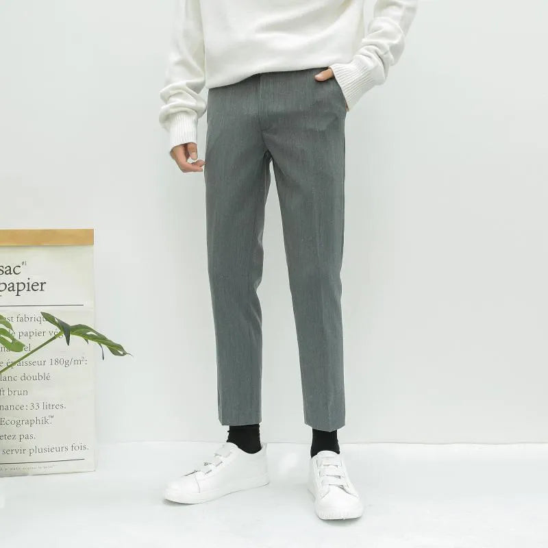 Men's slim straight-leg cotton trousers with a drawstring waist in black, shown front and side.