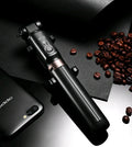 Aluminium telescopic Bluetooth selfie stick with tripod base and remote control next to a smartphone.