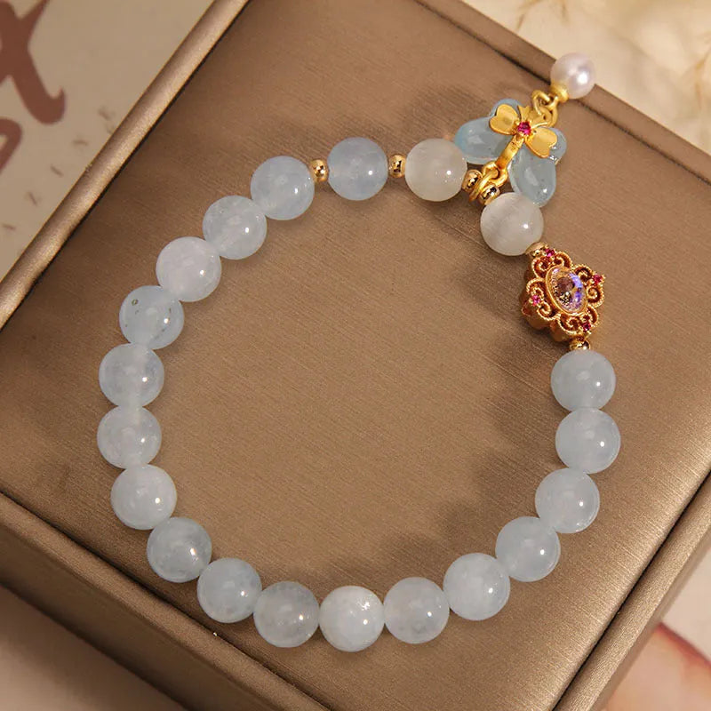 Women's aquamarine butterfly pendant crystal bracelet with rhinestone detailing on wrist