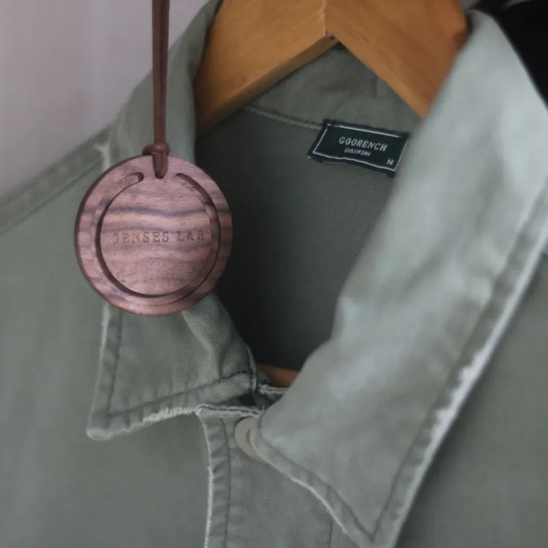 Round black walnut wood car air freshener pendant with jasmine green tea scent, 5cm diameter, brown colour variant