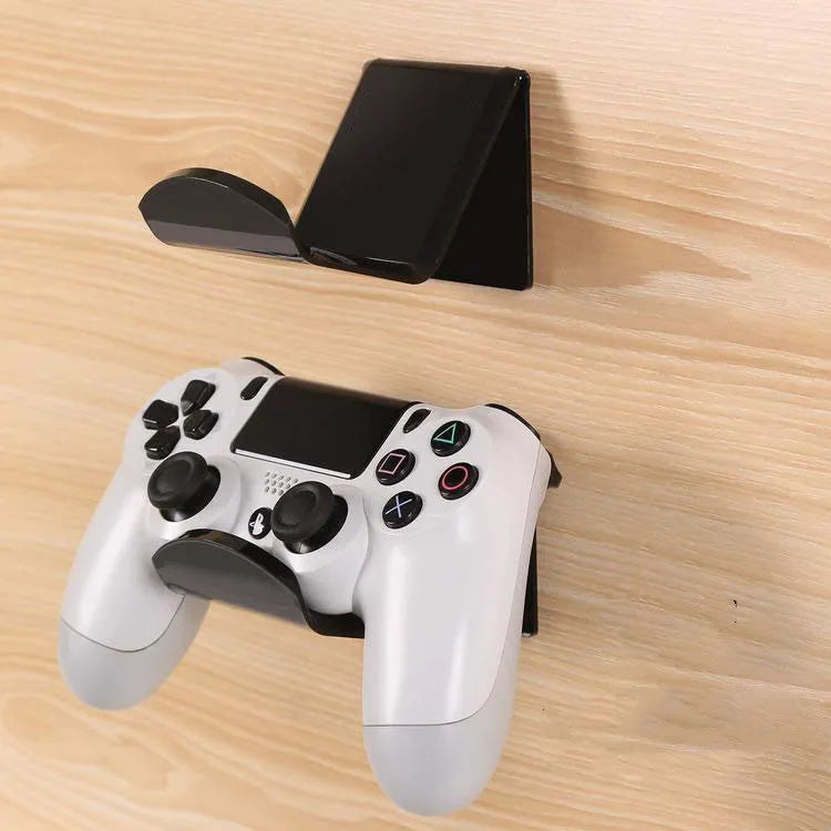 Plastic wall mounting bracket for video game controllers in black, white, or transparent finish.
