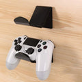 Plastic wall mounting bracket for video game controllers in black, white, or transparent finish.