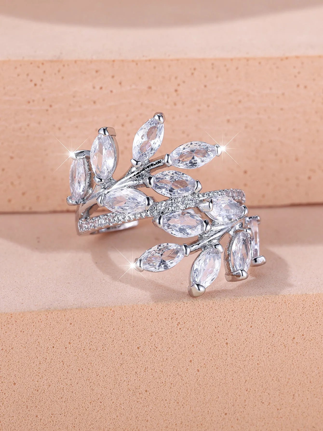 Adjustable copper leaf ring with a zircon stone in a choice of rose gold or platinum finishes.