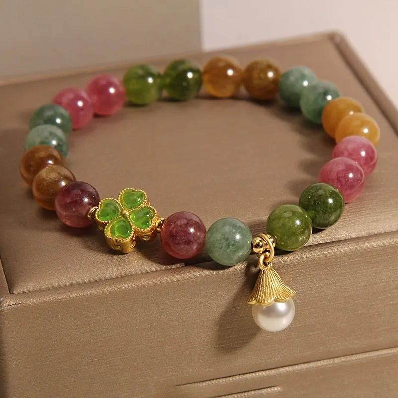 Coloured tourmaline bracelet with four-leaf clover pearl charm and geometric drop beads