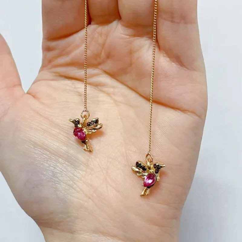Long, dangling bird-shaped earrings with zirconium wing details in red, blue, and red lvzuan colour options.