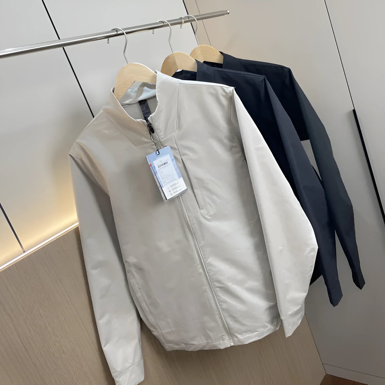 Men's black stand collar casual jacket with long sleeves and a straight hem.