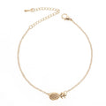 Women's alloy pineapple charm bracelet in gold or silver colour on a wrist.
