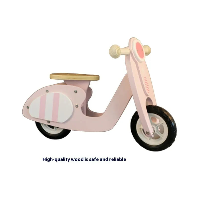 Pink wooden balance scooter for toddlers on a 10-inch wooden deck.