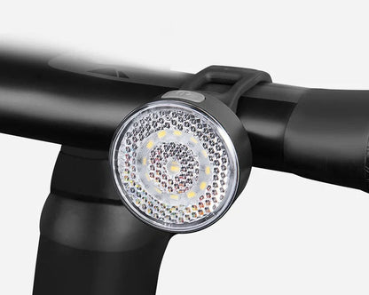 Bicycle LED headlight with clip attachment showing lens reflectors and USB port for charging