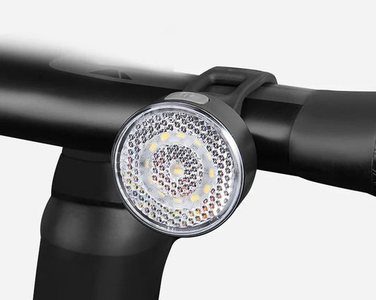 Bicycle LED headlight with clip attachment showing lens reflectors and USB port for charging