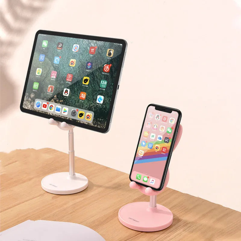 Rabbit-shaped silicone phone stand in pink on a desk with a smartphone placed in it
