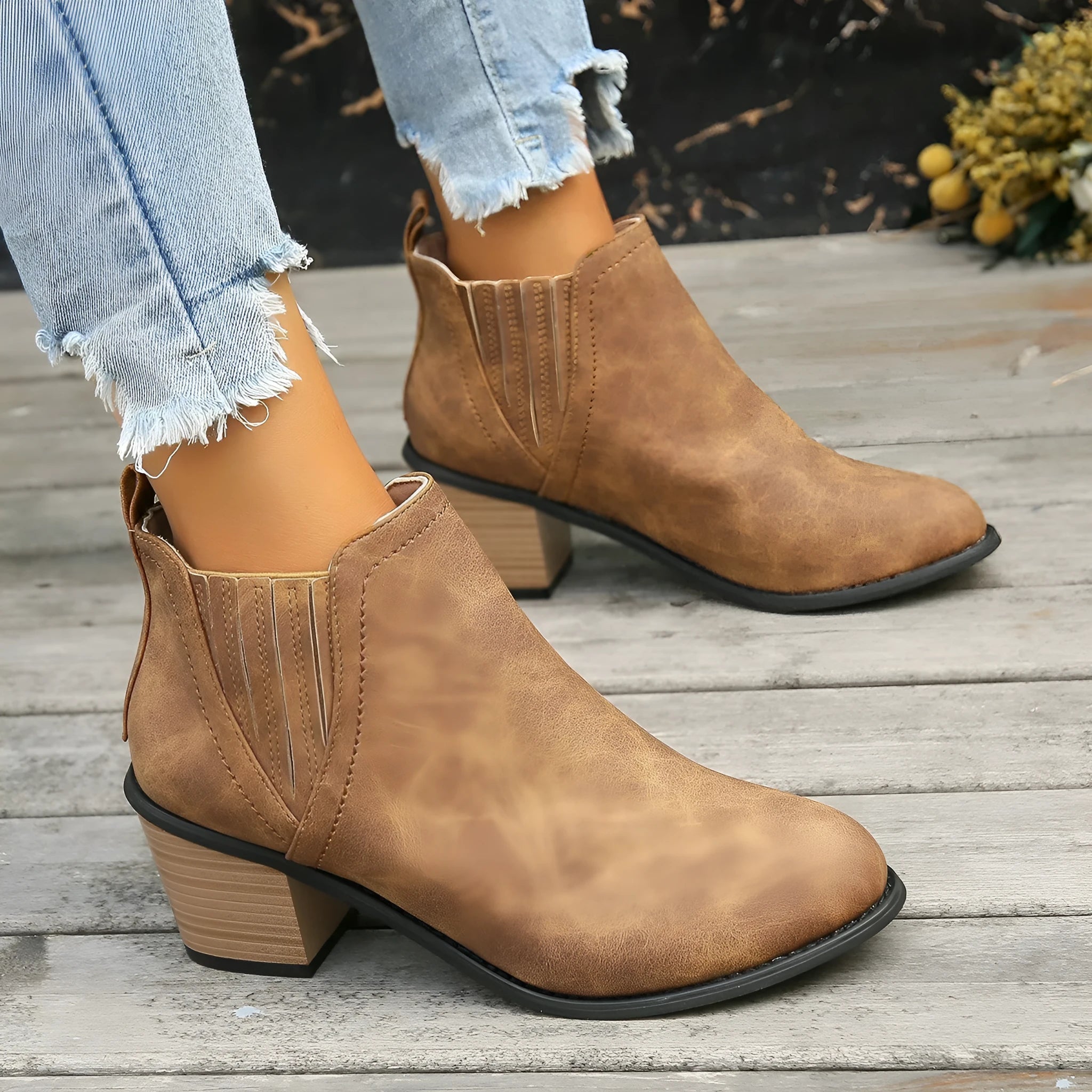 Black women's ankle boots with a pointed toe and thick square heel on a rubber sole.