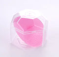 Silicone facial brush in three bristle zones with suction cup on blue background