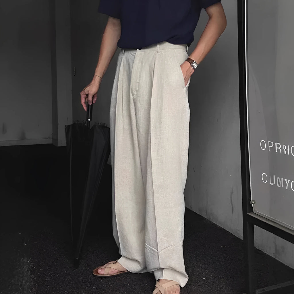 Men's apricot coloured wide-leg cotton linen suit trousers with a loose fit and pencil pants leg opening.