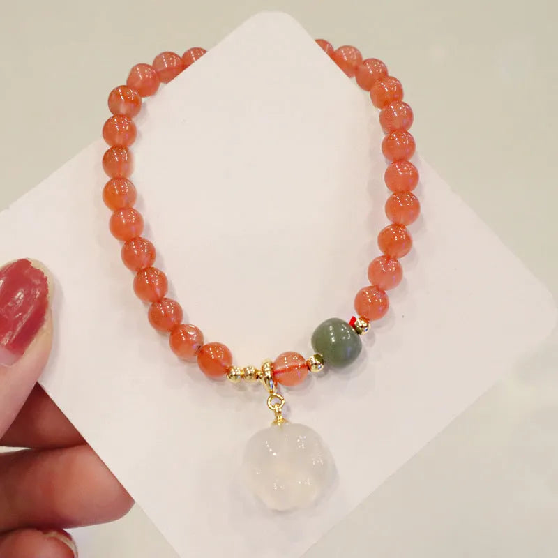 Polished red agate and green jade women's bracelet with a cat's paw charm.