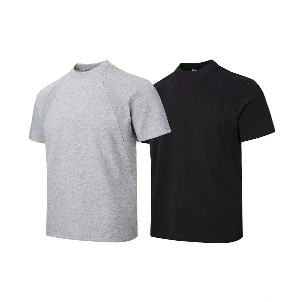 Man wearing a loose grey short sleeve top with visible air layer texture stitching on the front.
