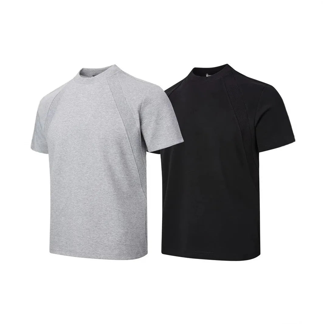 Man wearing a loose grey short sleeve top with visible air layer texture stitching on the front.
