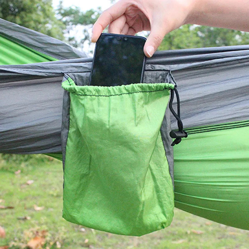 Blue nylon parachute cloth outdoor camping hammock hung between trees