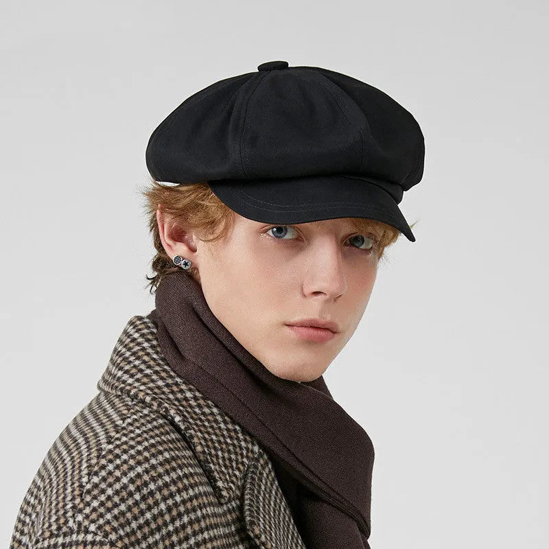 Cotton newsboy cap in black, octagonal dome crown, side view showing structure