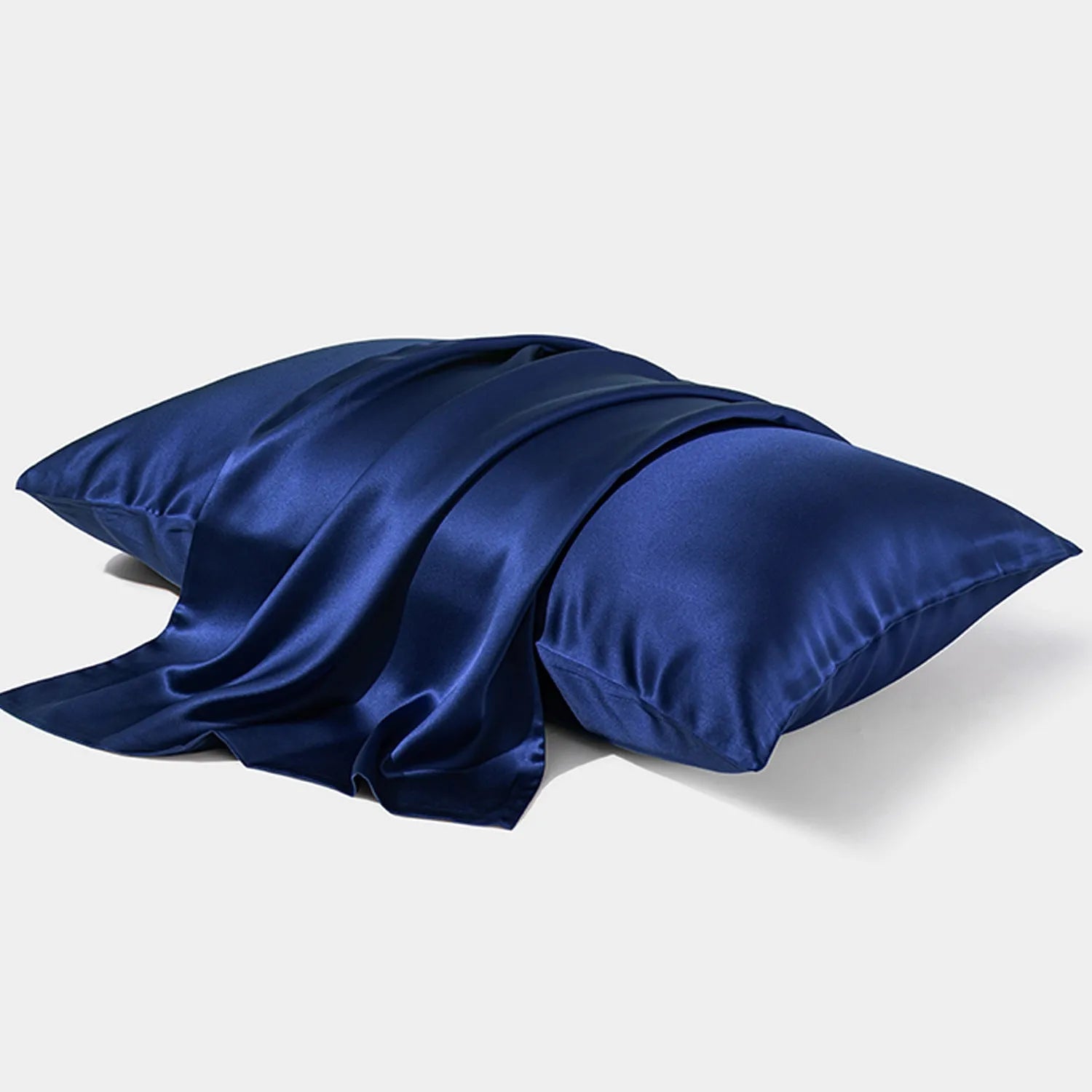 Dark grey mulberry silk pillowcase with envelope closure, shown in a modern bedroom setting.
