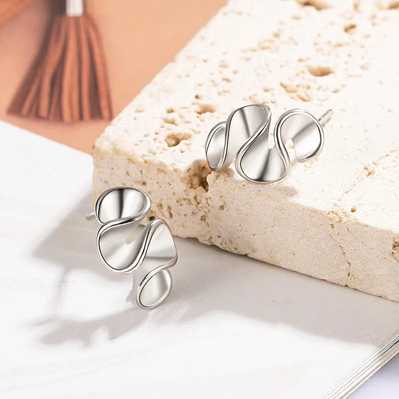 Geometric cream flower stud earrings in gold electroplated finish on copper base with irregular shape