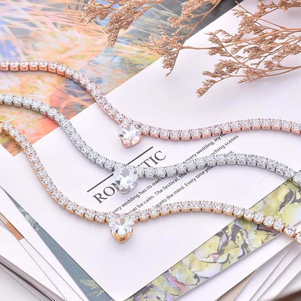 Gold rhinestone heart shaped pet collar with extension chain on white background